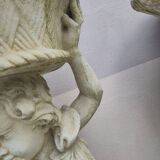 Antique reconstituted stone planter depicting a cherub