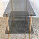 Coffee table in gilded metal and smoked glass – 60s