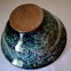 Bowl on a circular base or small blue ceramic dish.