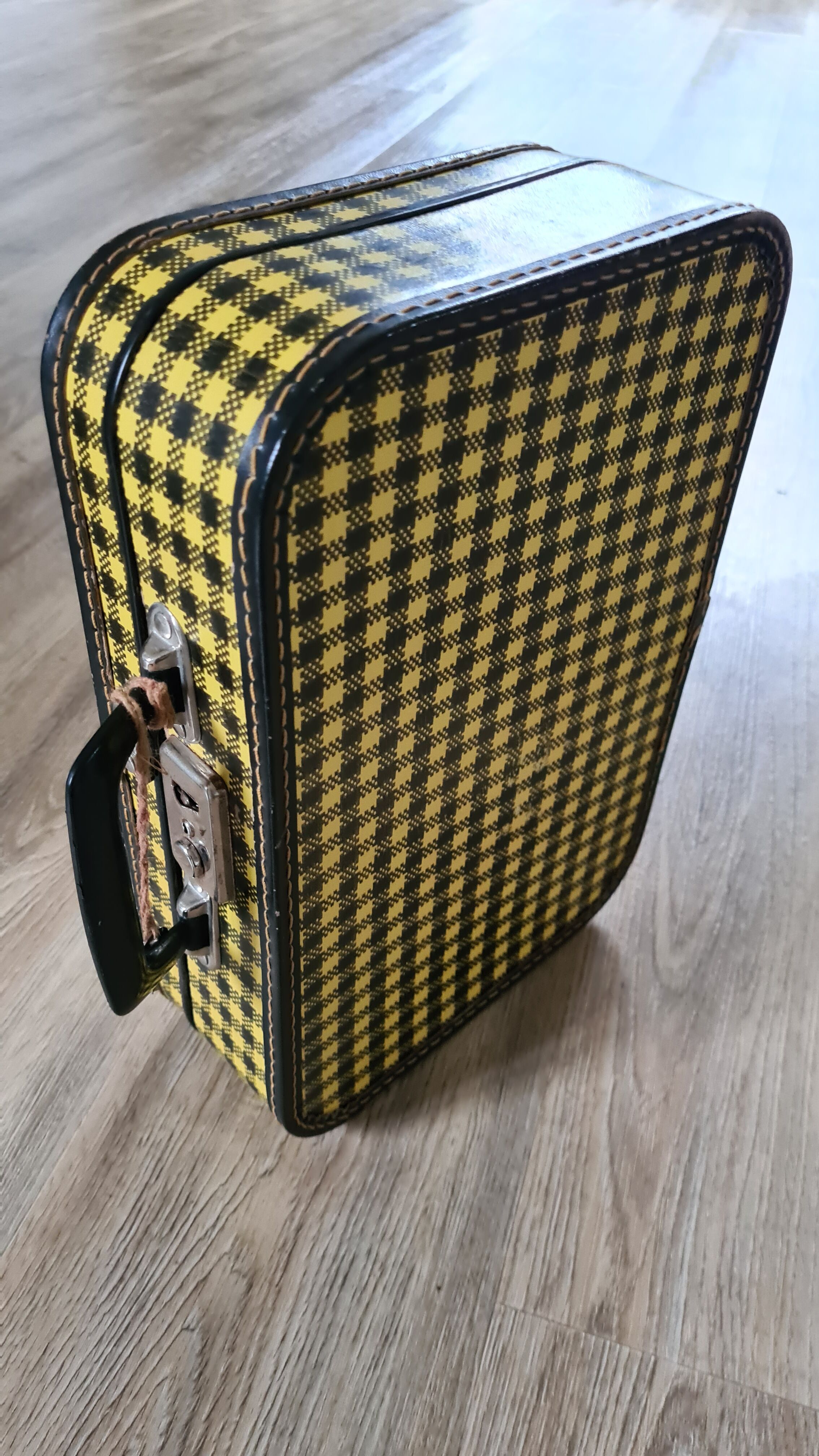 Antique suitcase in vintage yellow and black cardboard