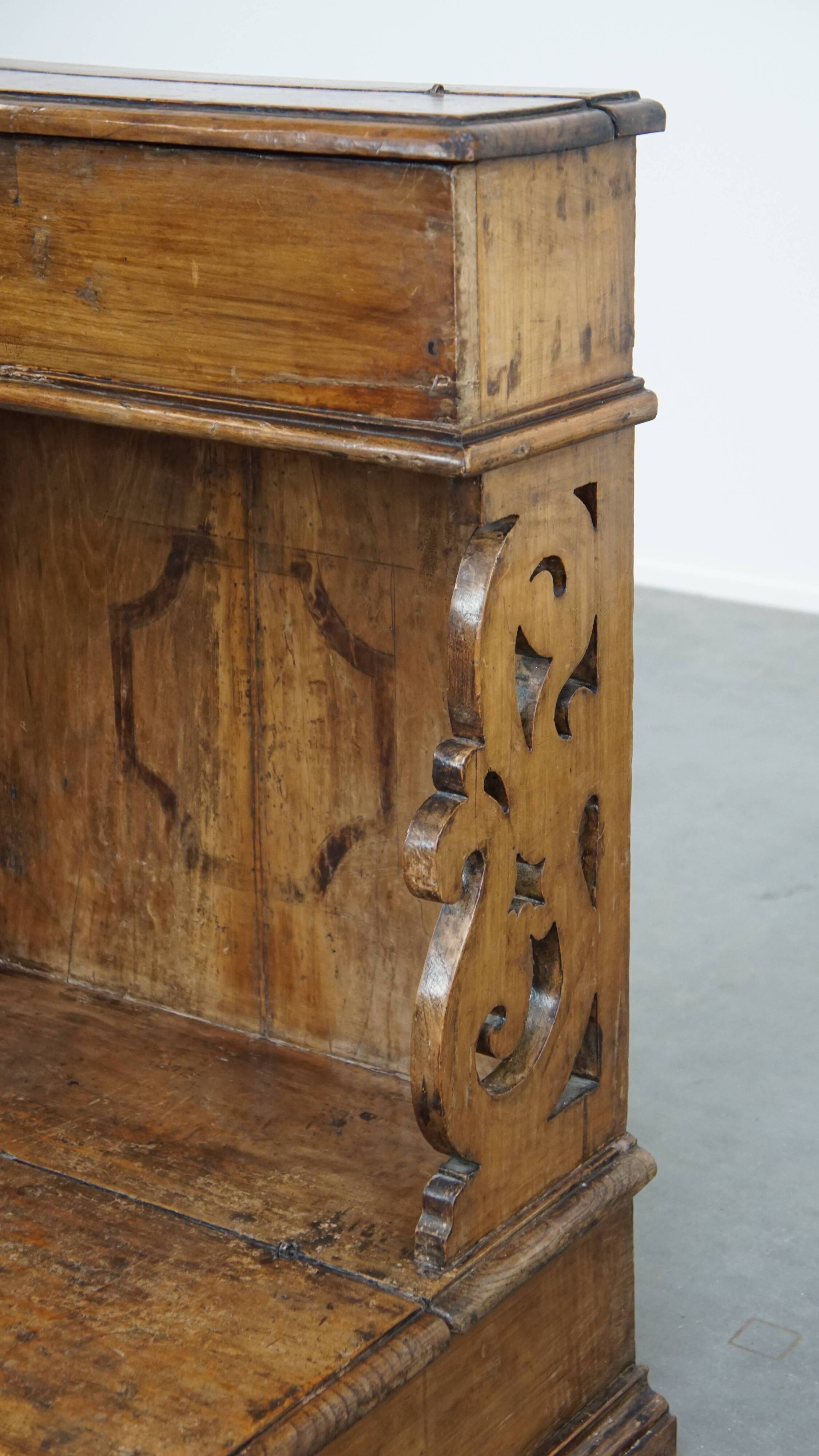 Antique pinewood church pew with storage compartments from the 18th century