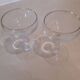Two small crystal champagne glasses with twisted stems.