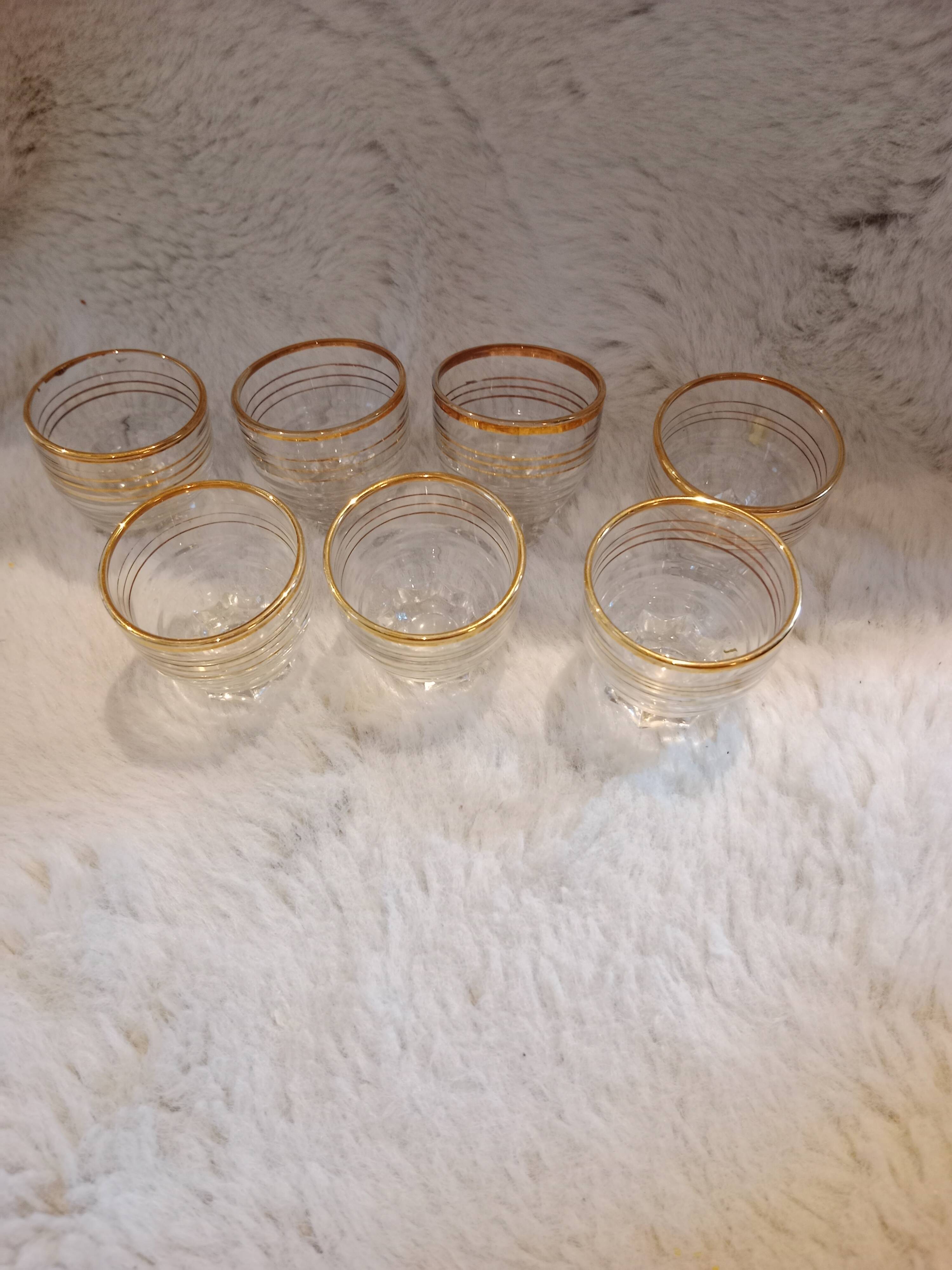 7 vintage mini shot glasses.