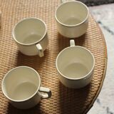 A set of 4 Sarreguemines ecru and gold earthenware cups