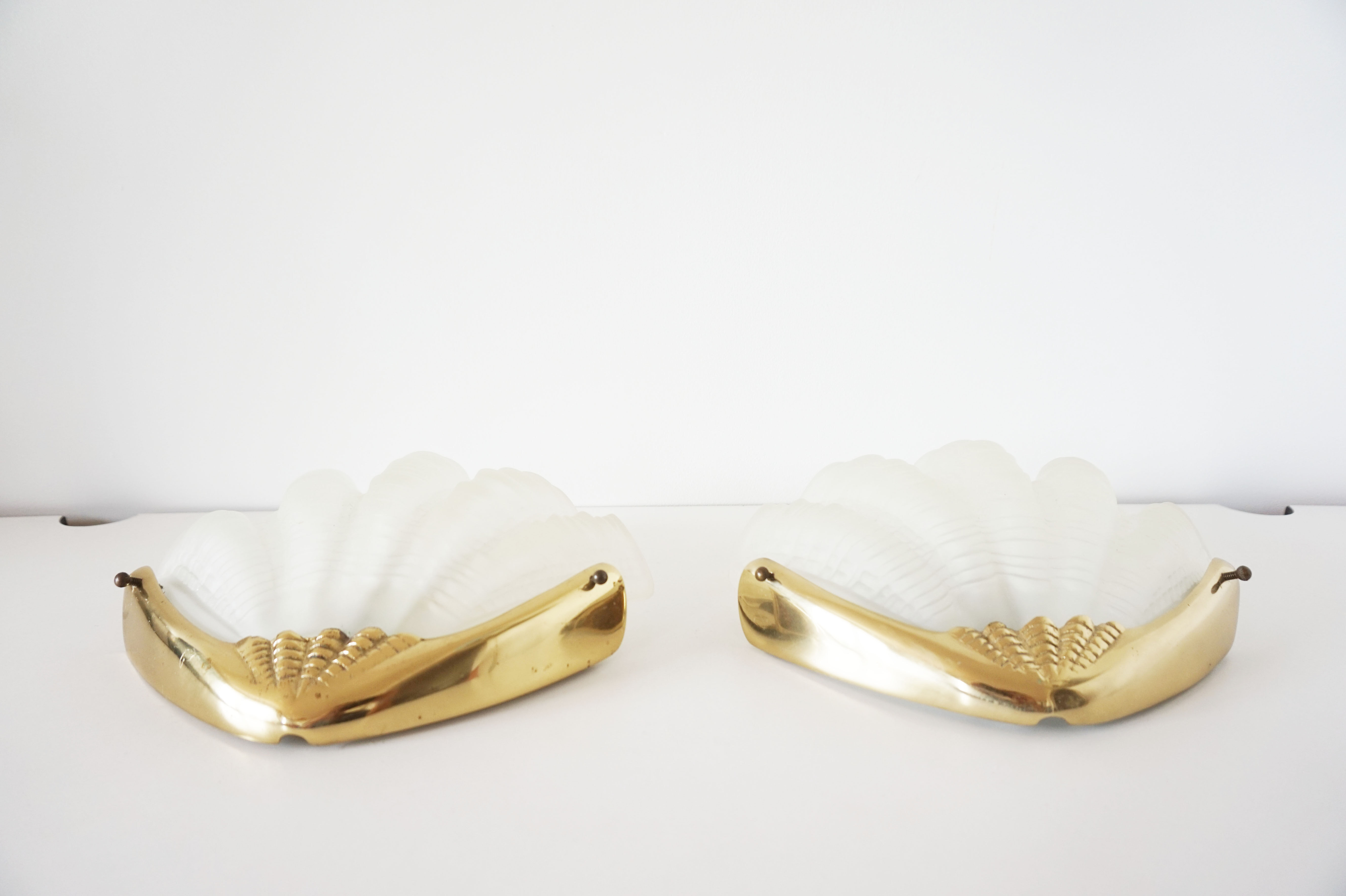 Pair of glass and gold metal shell sconces