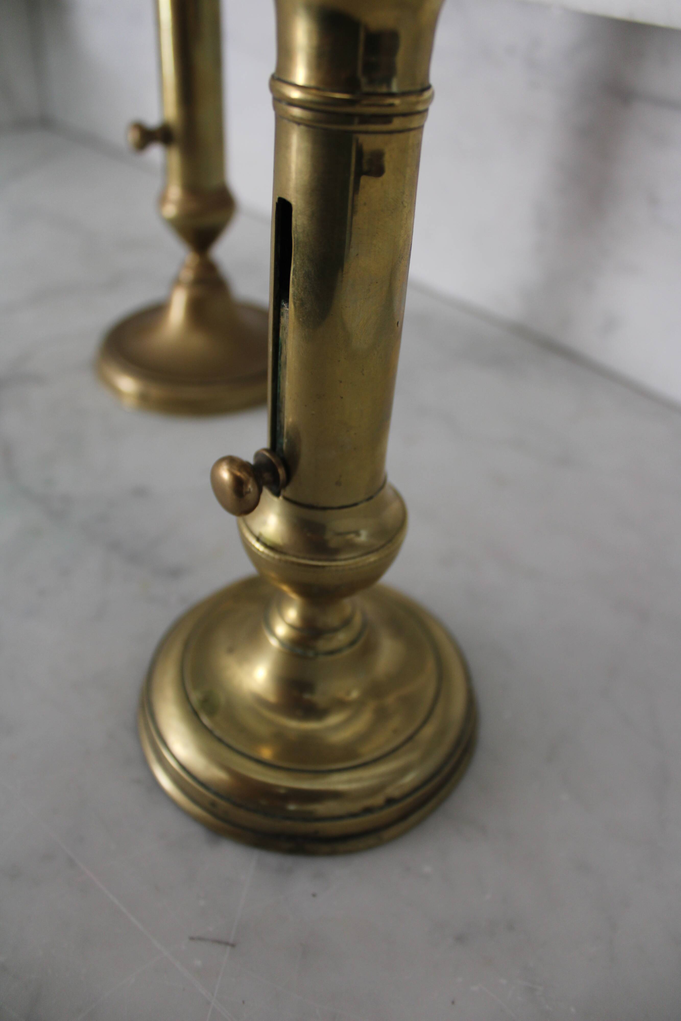 Pair of brass pusher candlesticks