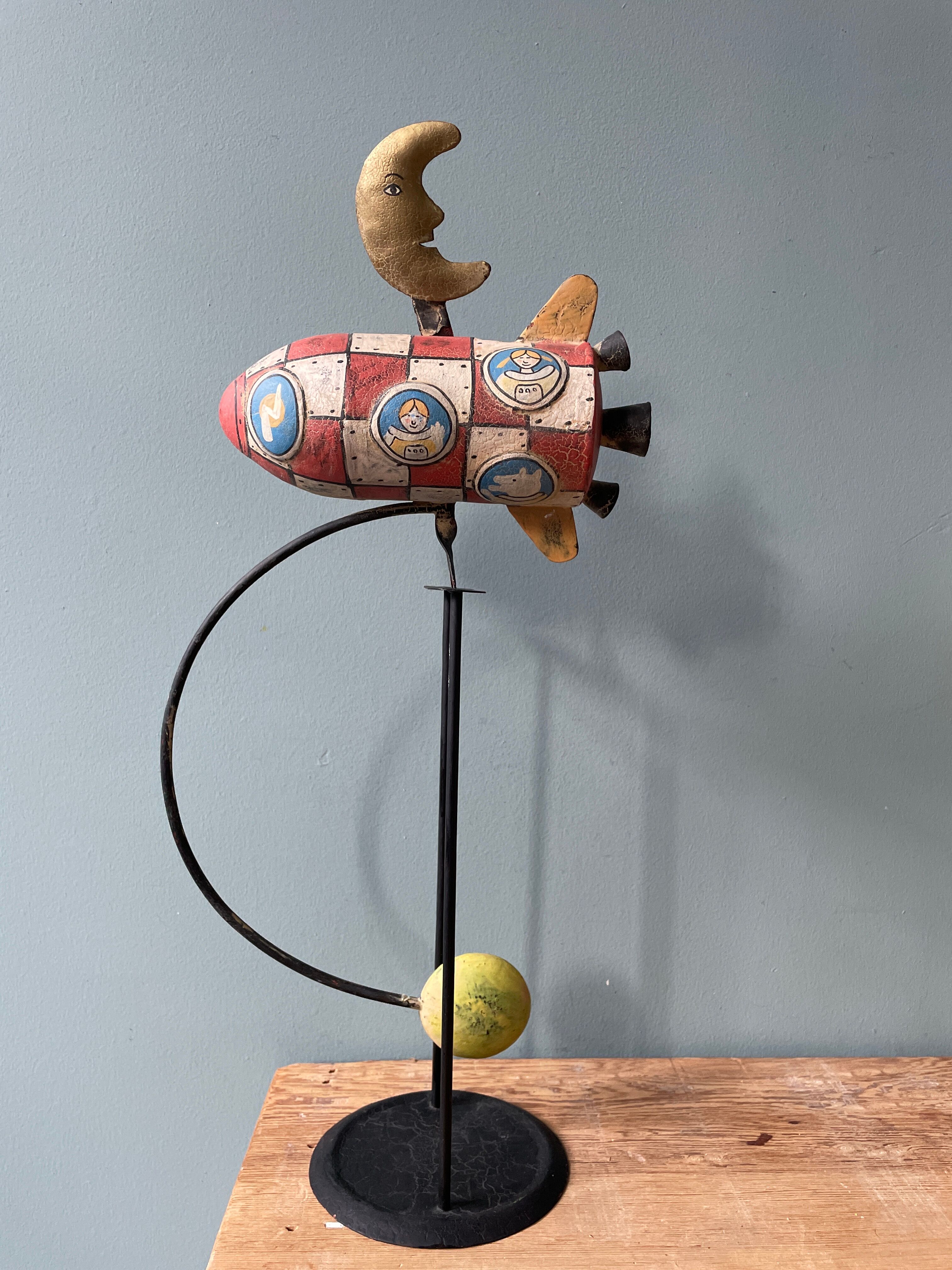 Old painted sheet metal pendulum toy