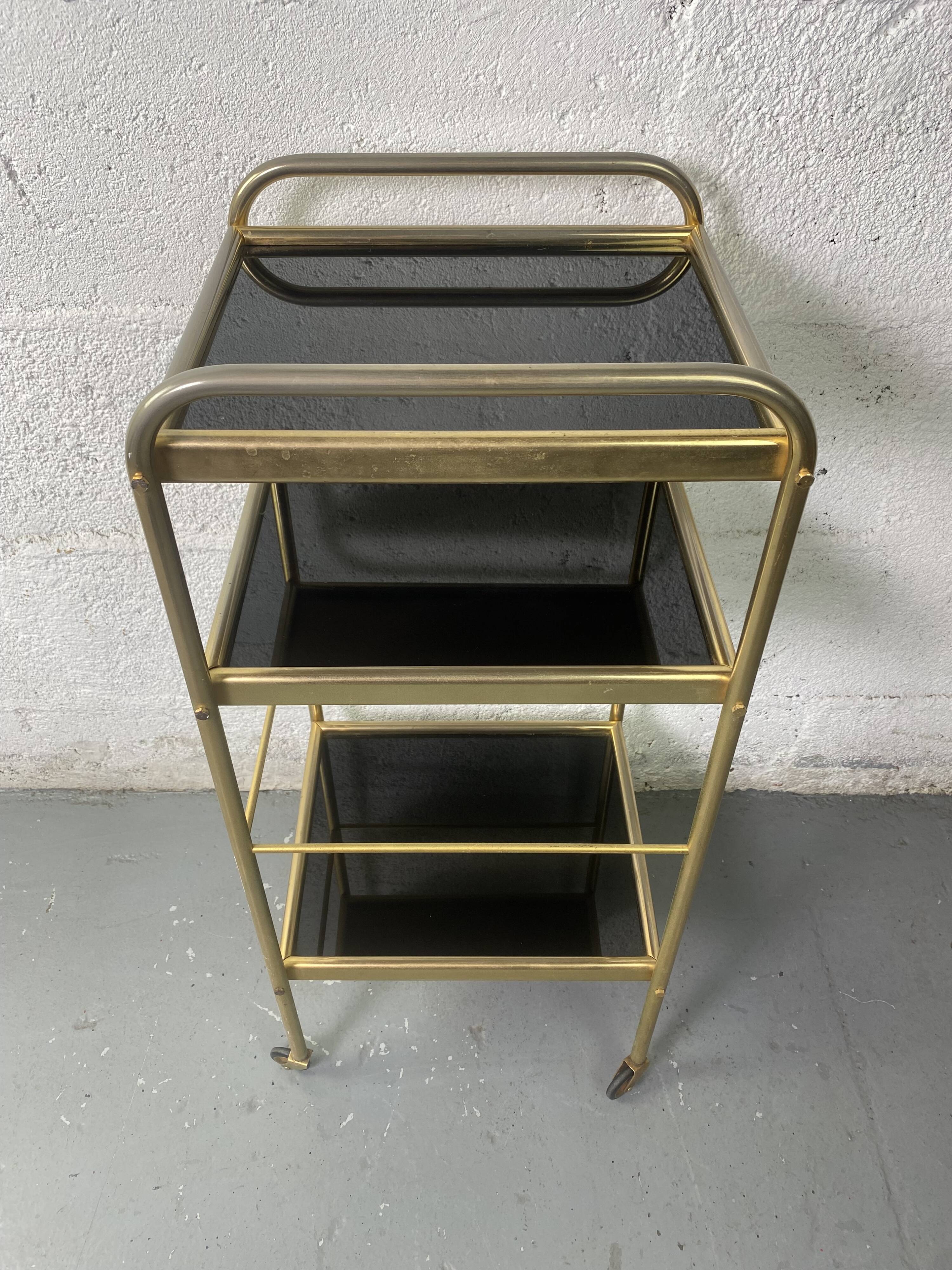 Small rolling trolley in brass and black plastic