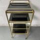 Small rolling trolley in brass and black plastic