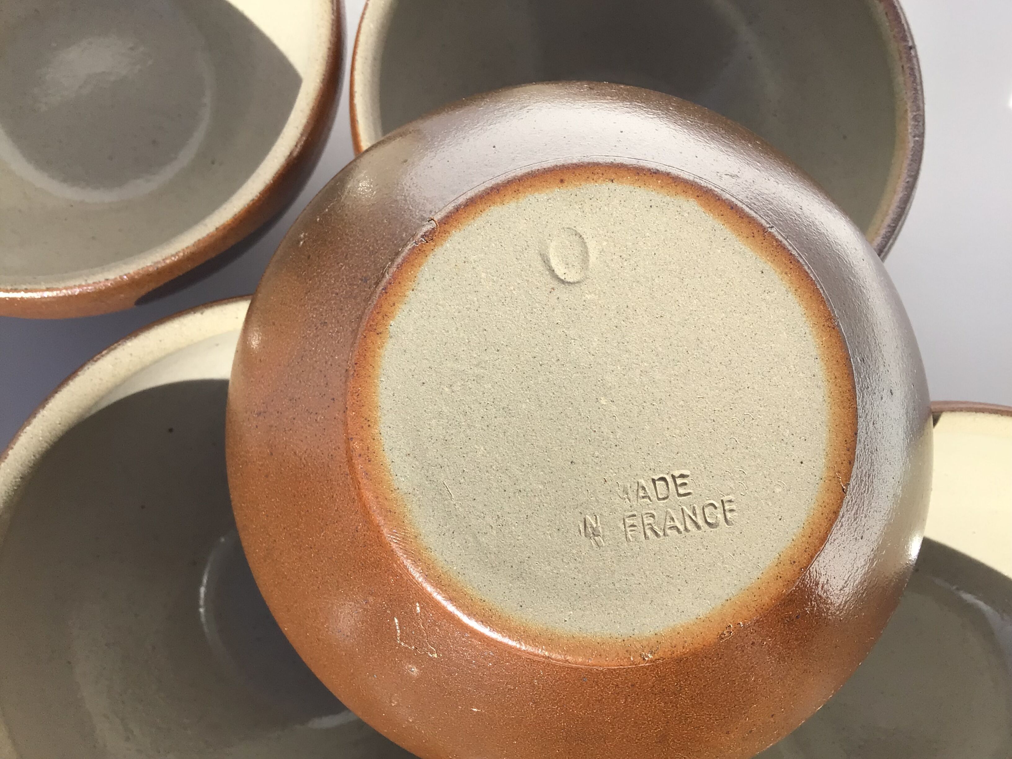 6 iridescent brown sandstone bowls inside grey
