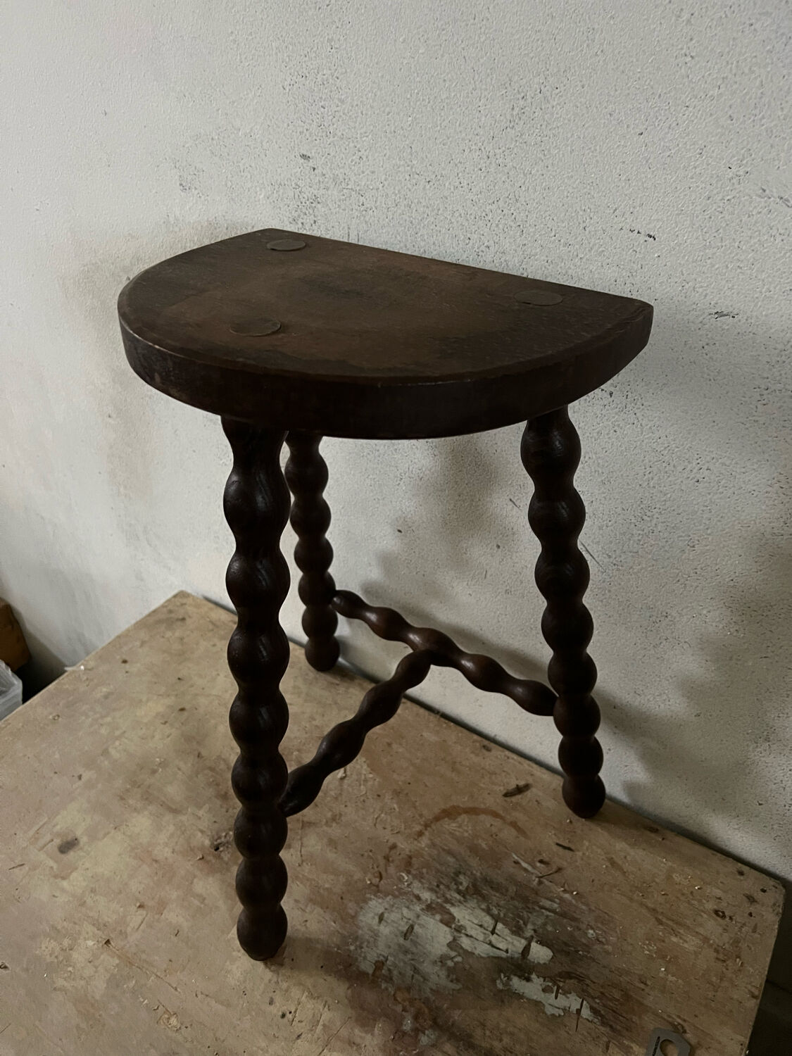 Wooden tripod farm stool