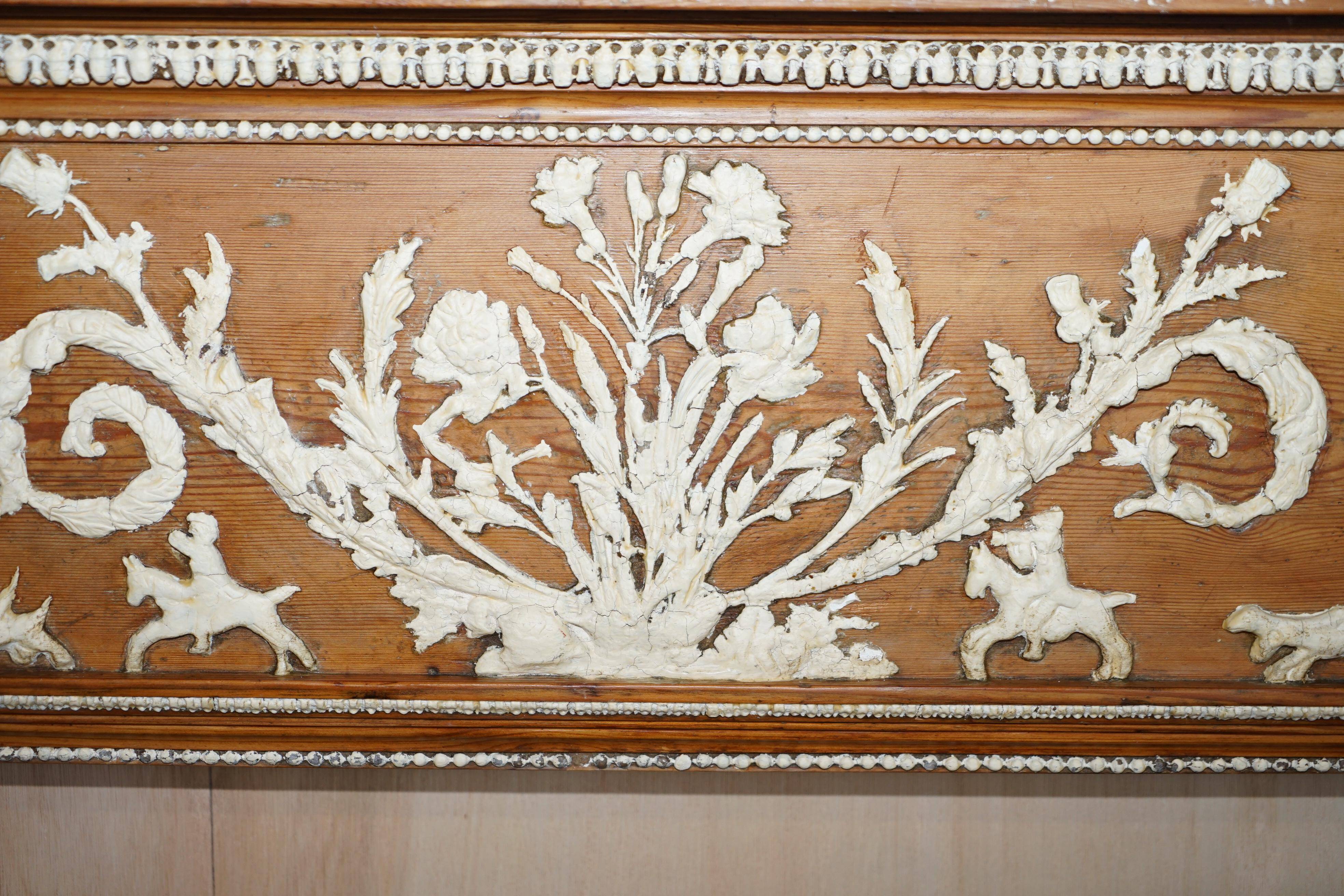 Victorian antique fireplace in tarred pine and sculpted gesso.