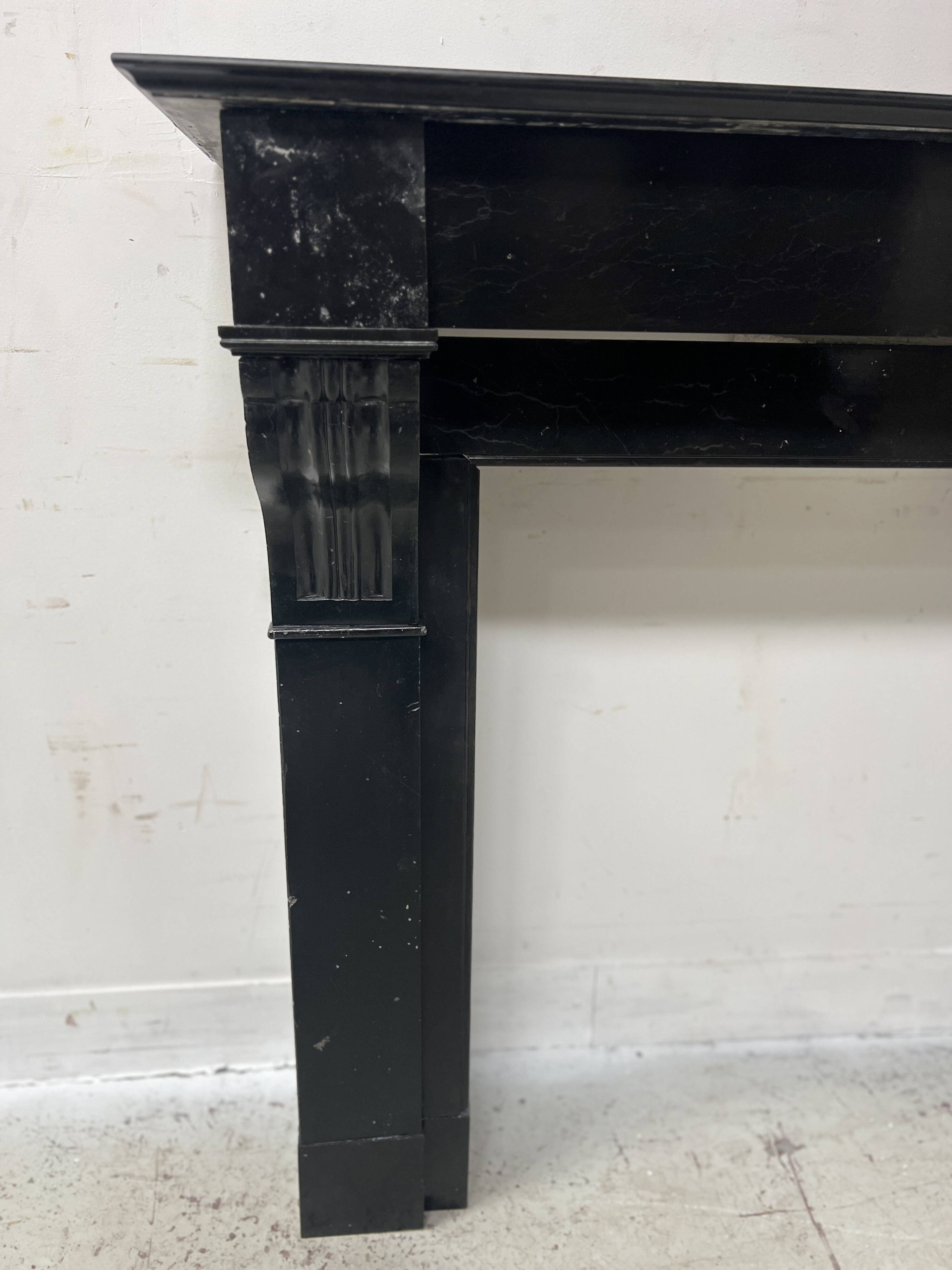 Napoleon III period fireplace with a black marble corbel. 19th century.