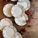 Set of 10 vintage white and gold dessert plates.