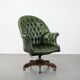 Large Chesterfield office armchair in green cowhide, in English style, on wheels.