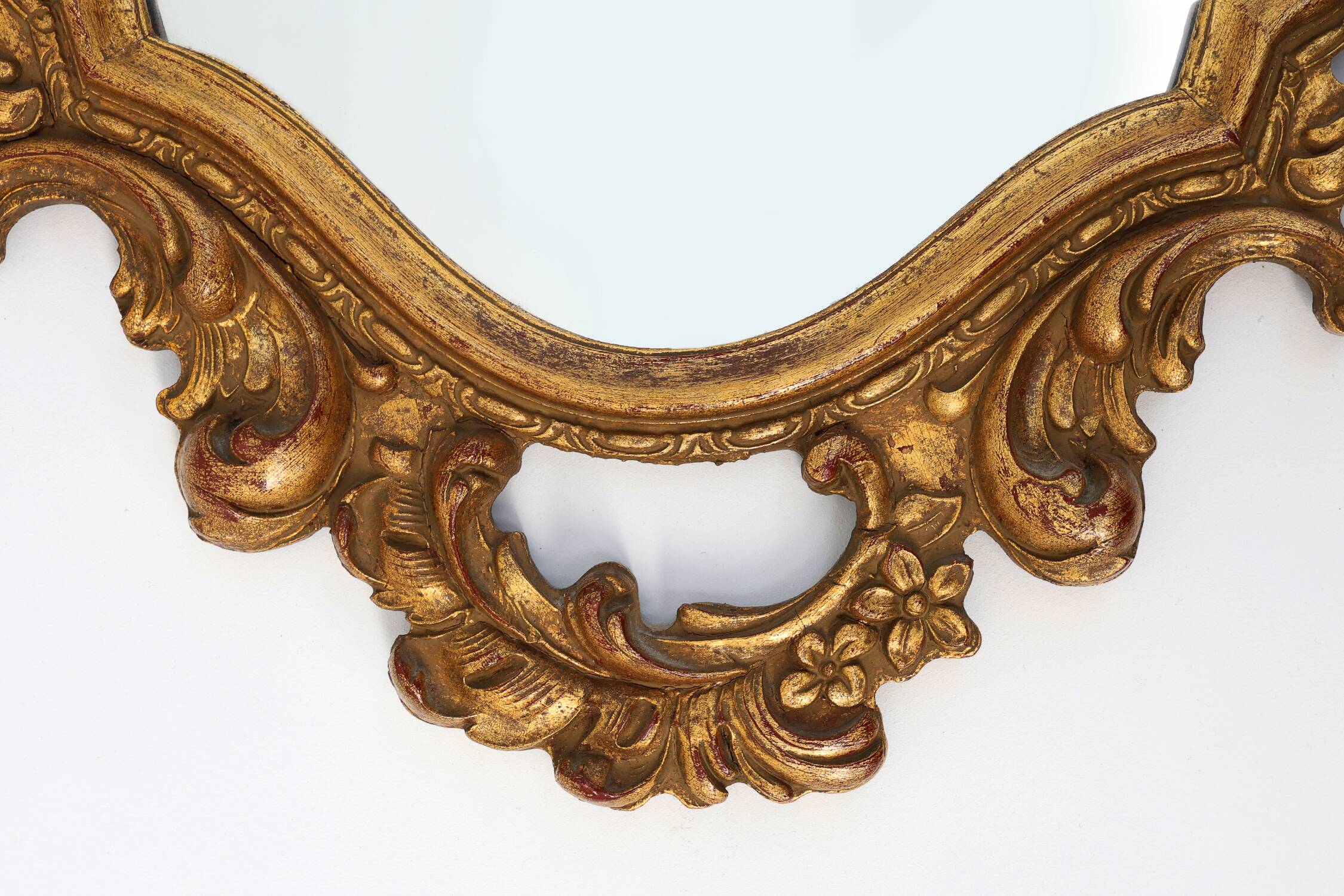 Baroque style oval wall mirror in gilded wood, France