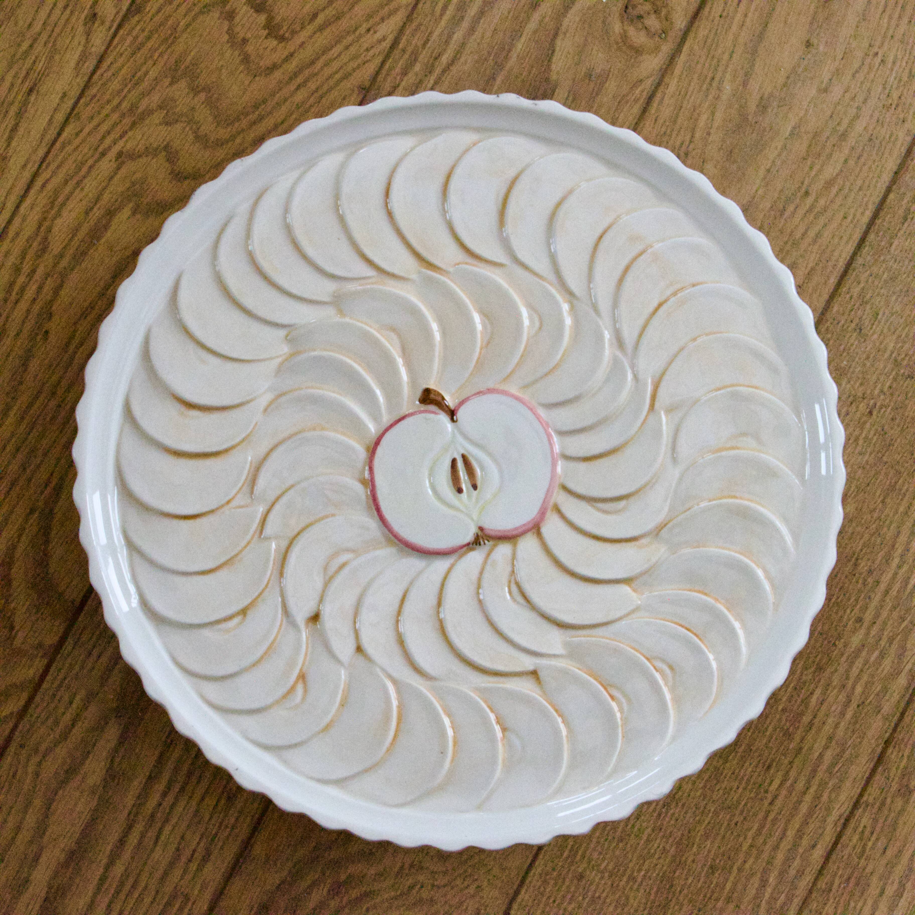 Large vintage earthenware pie dish on a pedestal, apple pie