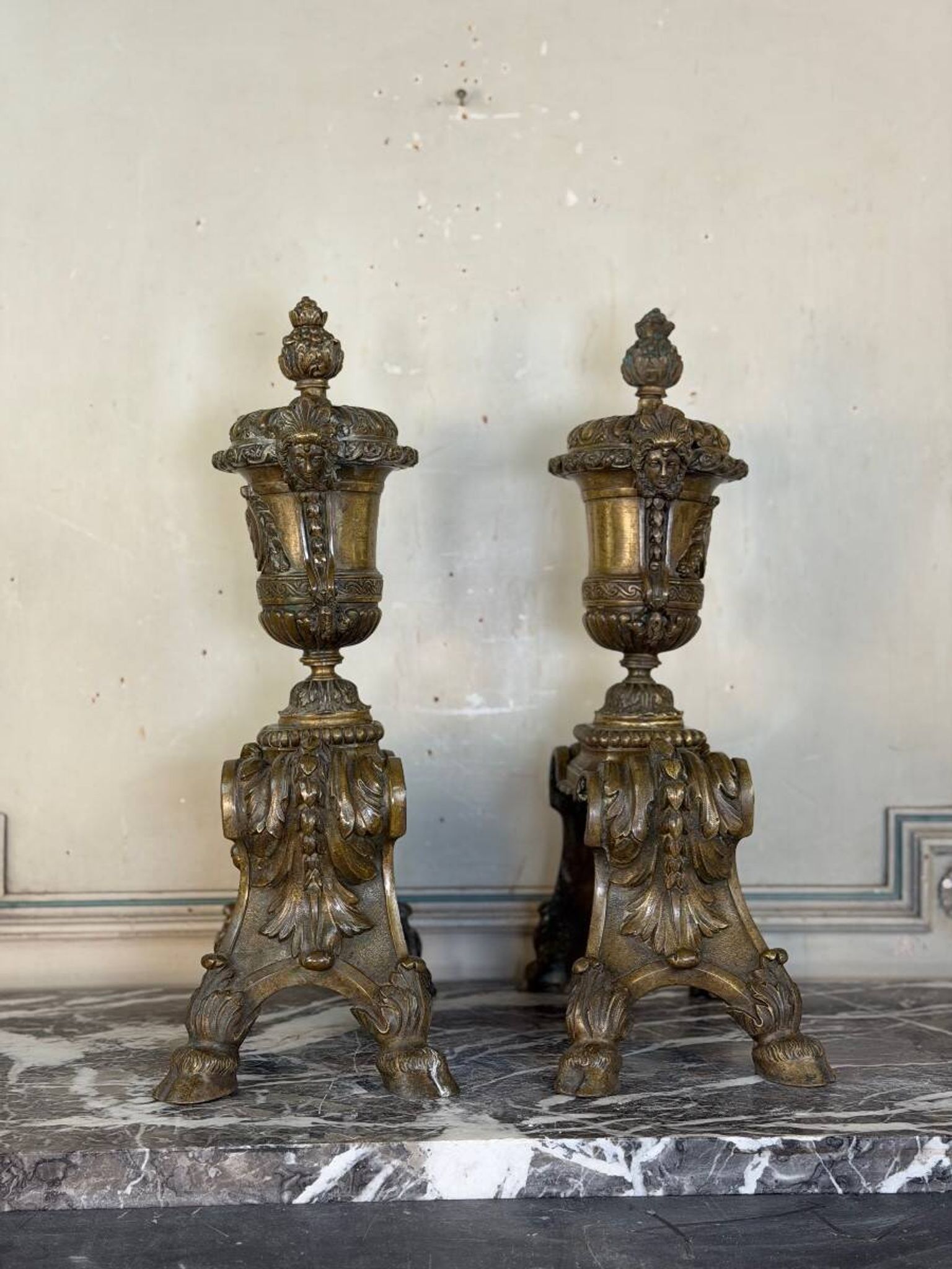 Pair of Louis XIV style andirons in bronze after a design by André-Charles Boulle.