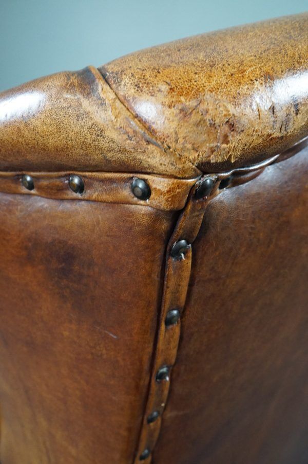 Antique armchair in patinated sheepskin