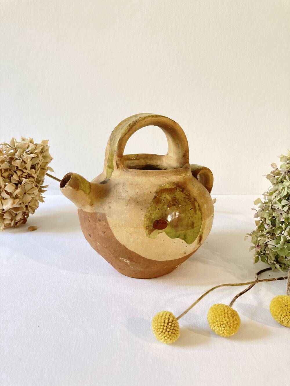 Small Provençal goat jug in creamy white and green enamelled stoneware