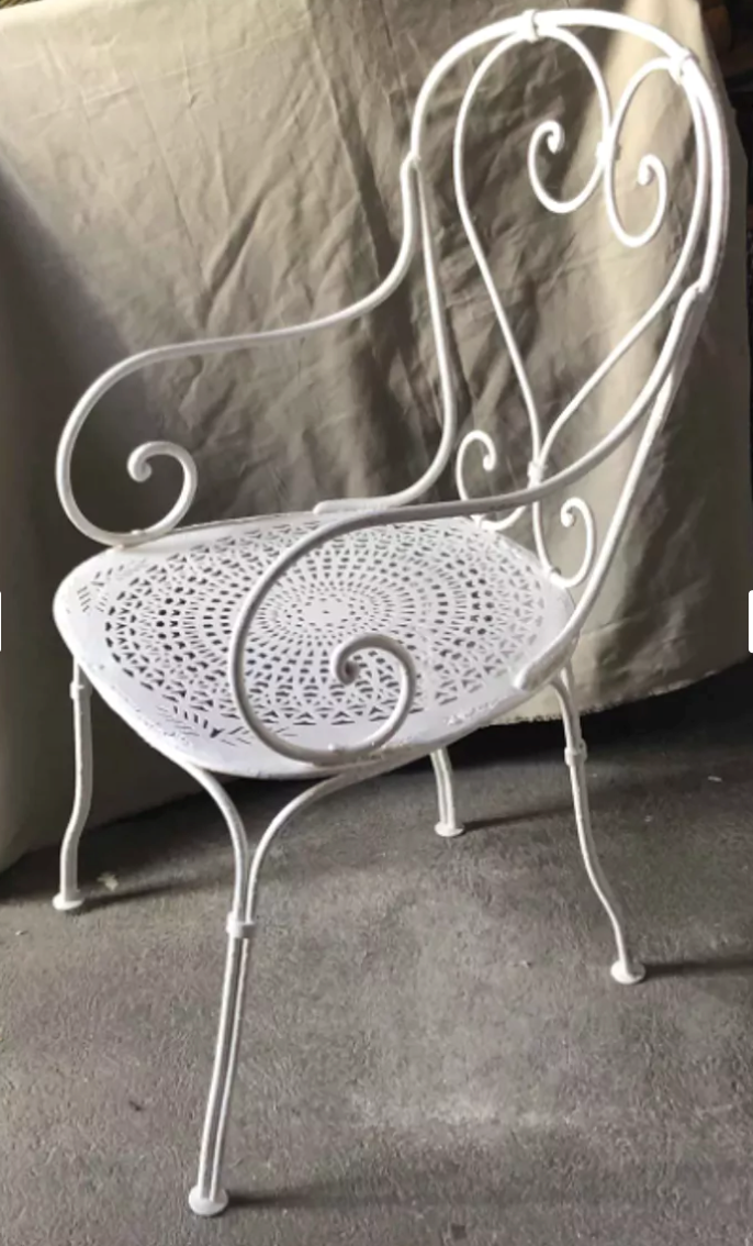 White openwork wrought iron armchair