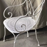 White openwork wrought iron armchair
