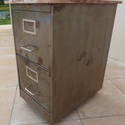 Vintage industrial metal furniture with a rusty effect, featuring two drawers on wheels.