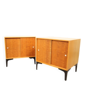 A pair of vintage mid-century bedside tables with oak sliding doors