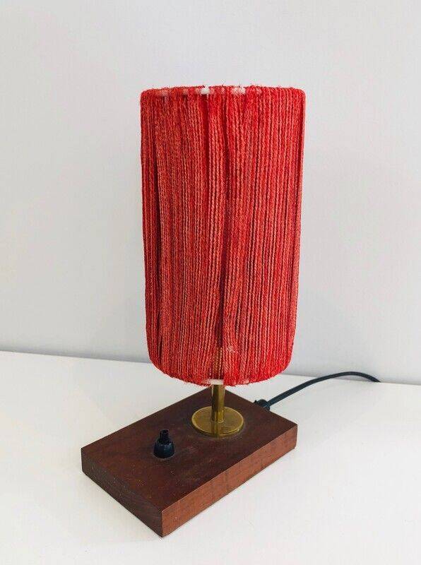 Small lamp made of wood, brass, and wool.