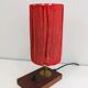 Small lamp made of wood, brass, and wool.