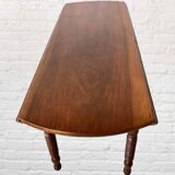 Oval walnut table with flaps