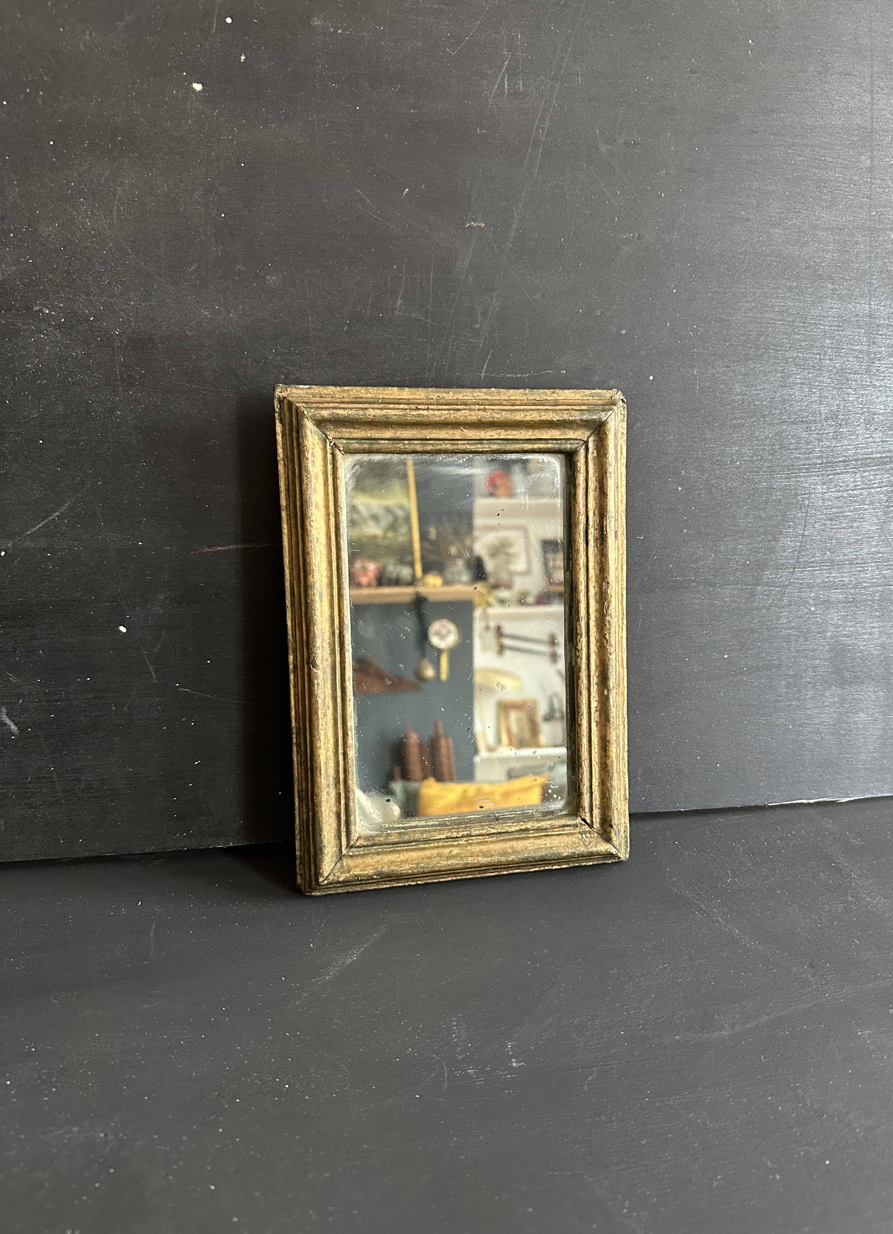 Miniature mirror from the 18th century in gilded wood, mercury glass.