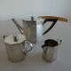 Antique silver Art Deco teapot, sugar bowl, and milk jug.