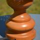 Large wooden lamp with a woven rattan shade.