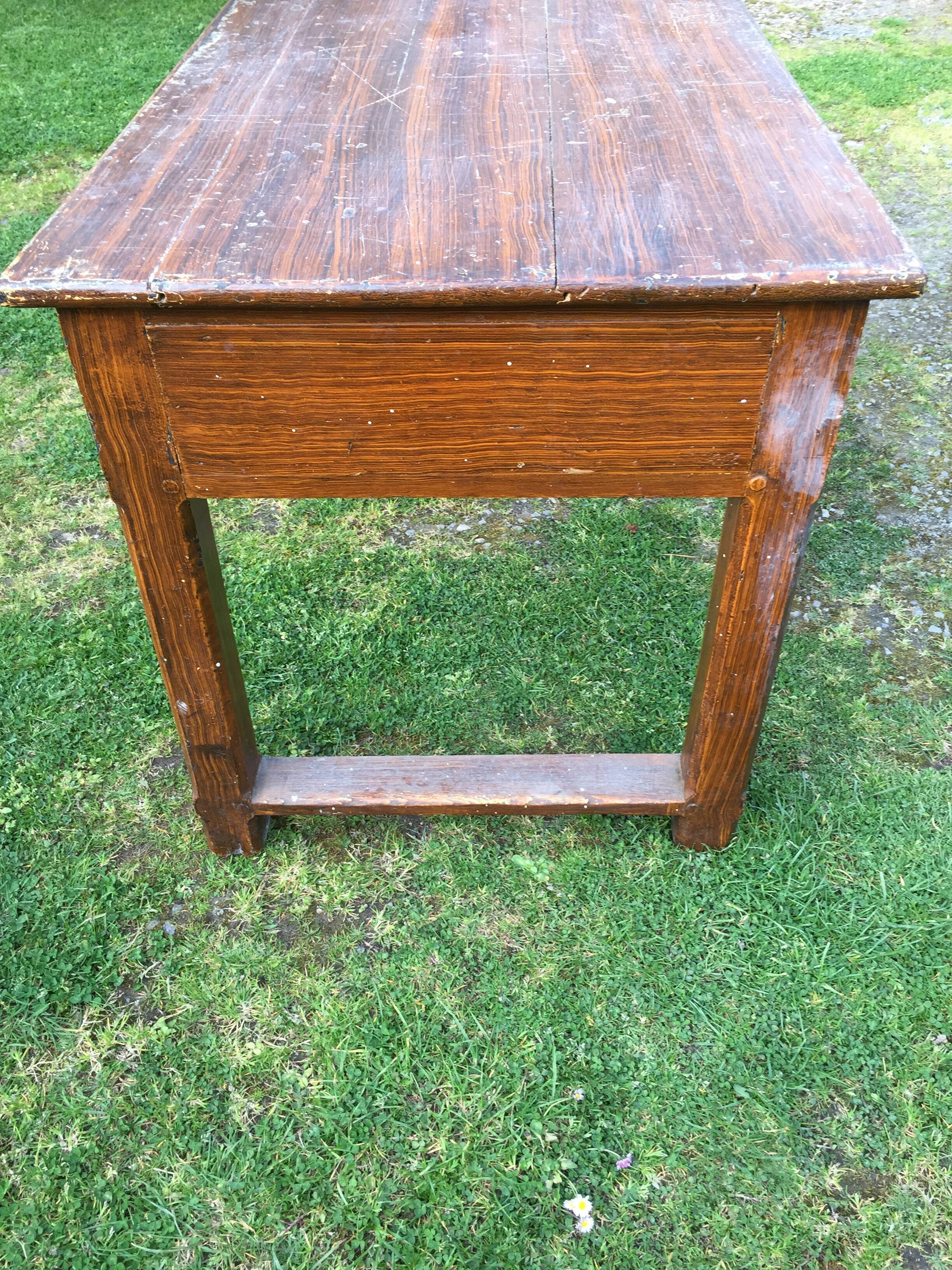 Old farmhouse table in oak painted faux wood old painting.