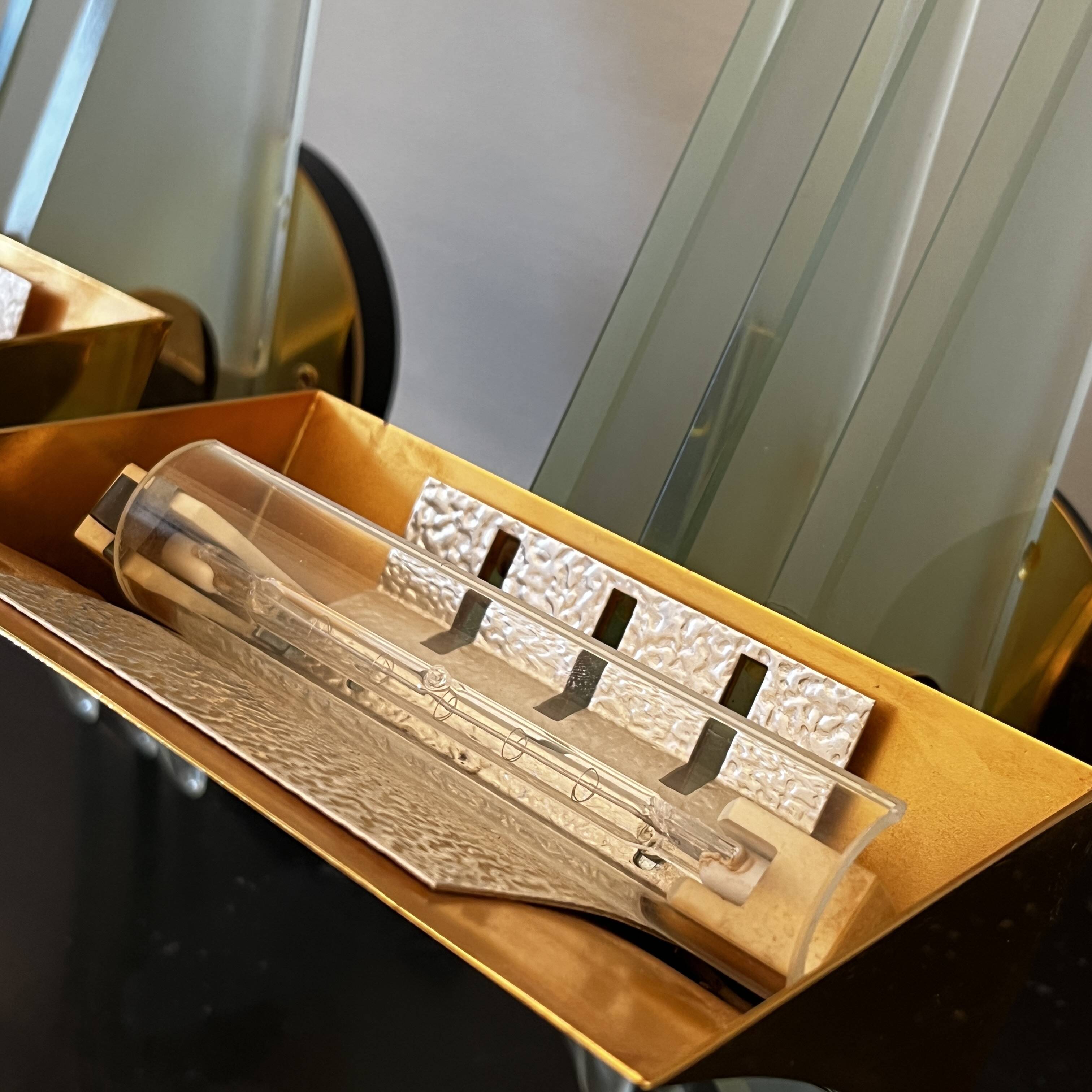 Pair of Hollywood Regency wall lights, bases & reflectors in gilded brass