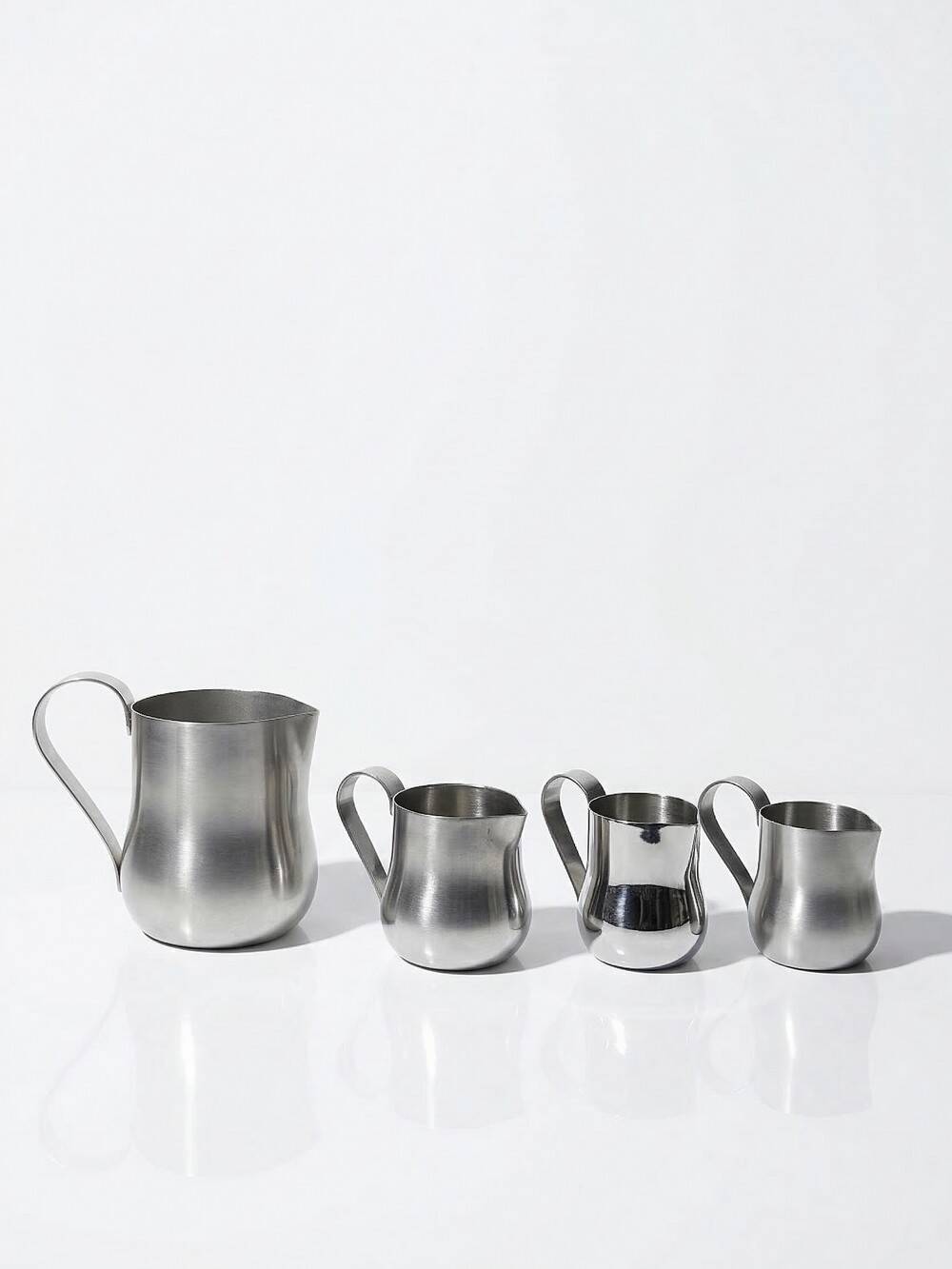 Set of 4 vintage bar measures in brushed stainless steel from the 60s-70s.