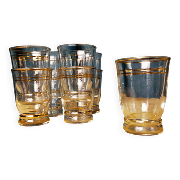 Set of 9 antique glasses with gold rim.
