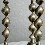 Three metal candle holders, twisted design, patinated finish, vintage style.