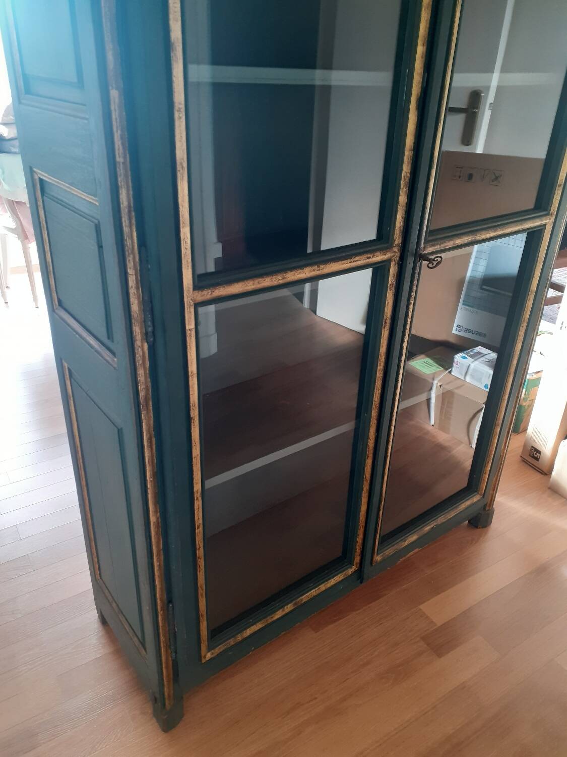 Glass-fronted cabinet in weathered green wood