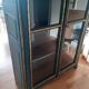 Glass-fronted cabinet in weathered green wood