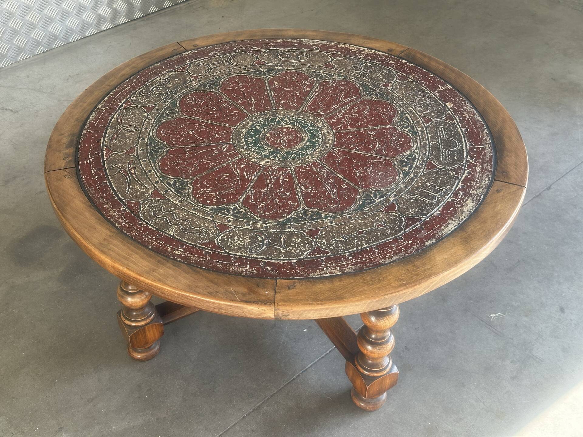 Vintage coffee table in turned wood and leather with astrological decoration.