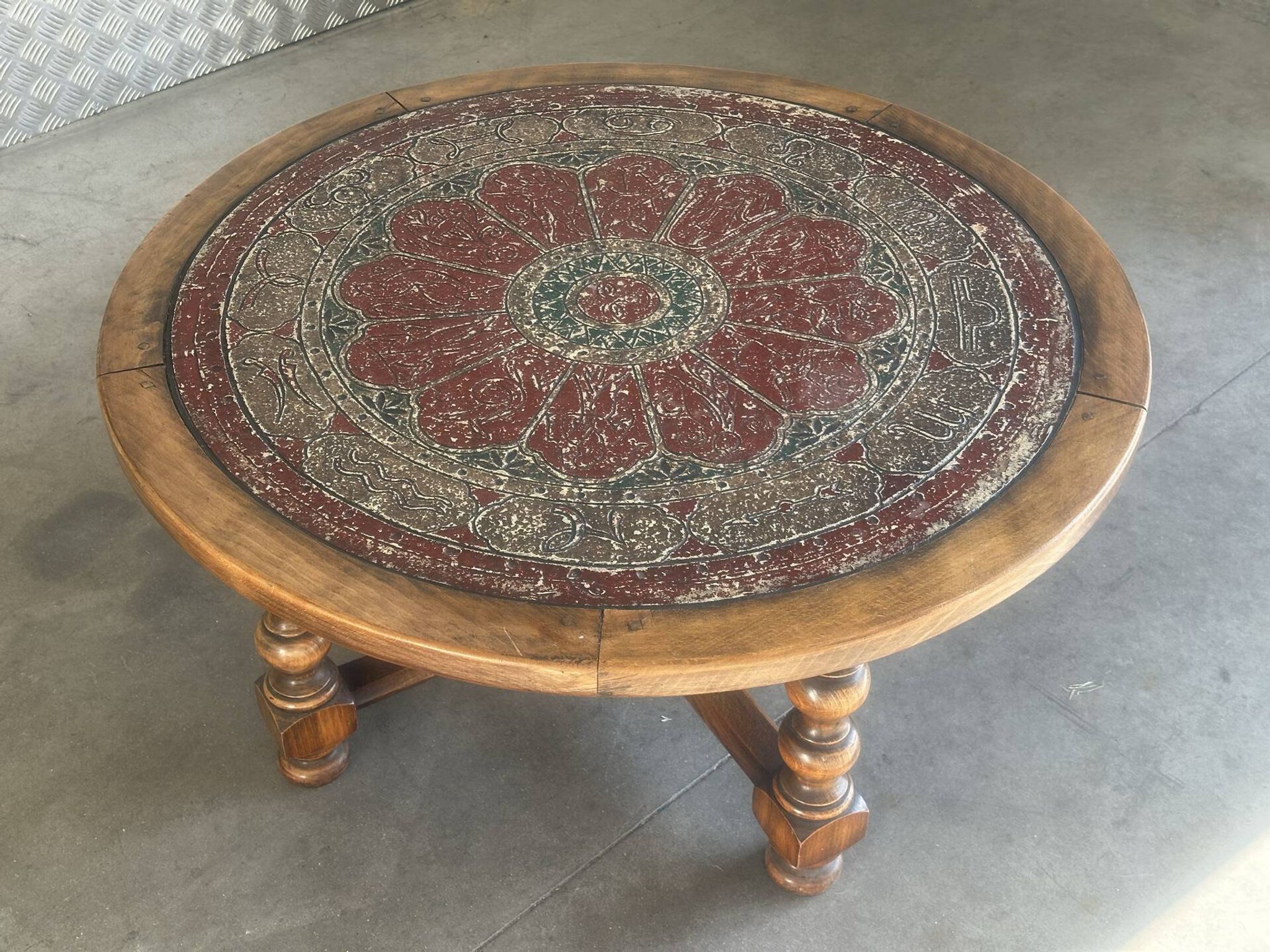 Vintage wooden turned coffee table with leather and astrological decoration.