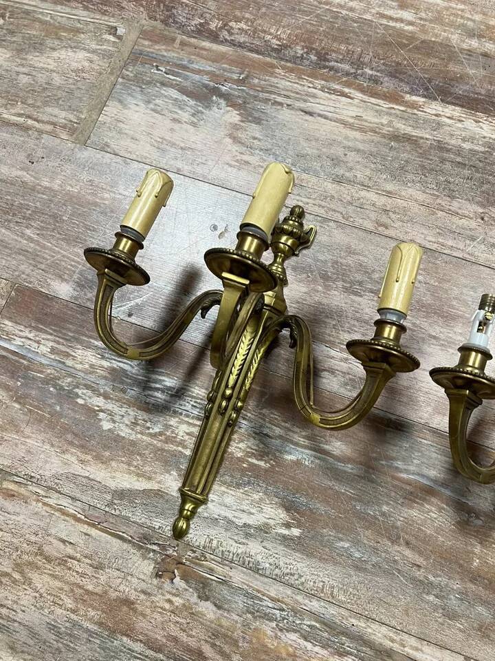 Pair of Louis XVI style gilt bronze wall lights with two light arms, 20th century