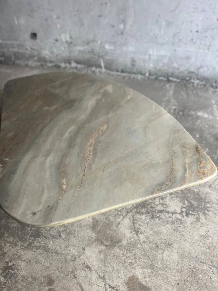 Light gray solid granite coffee table with organic triangular shape and conical base, 1980s
