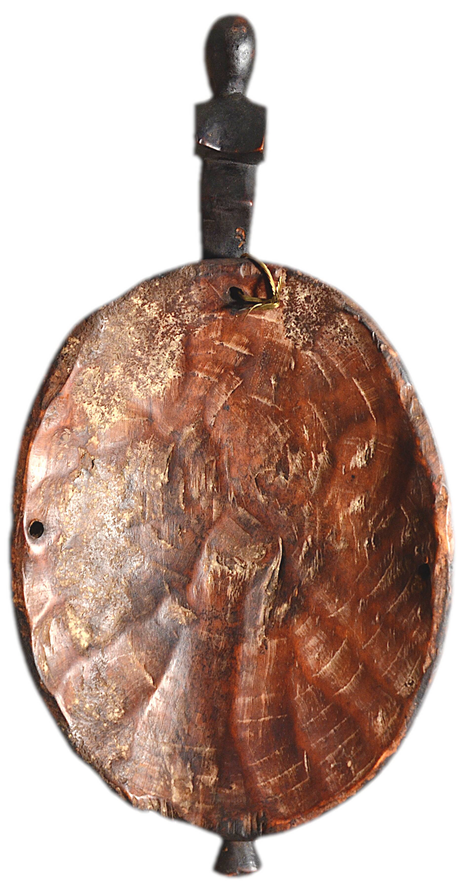 African wooden mask, face topped with a bird.