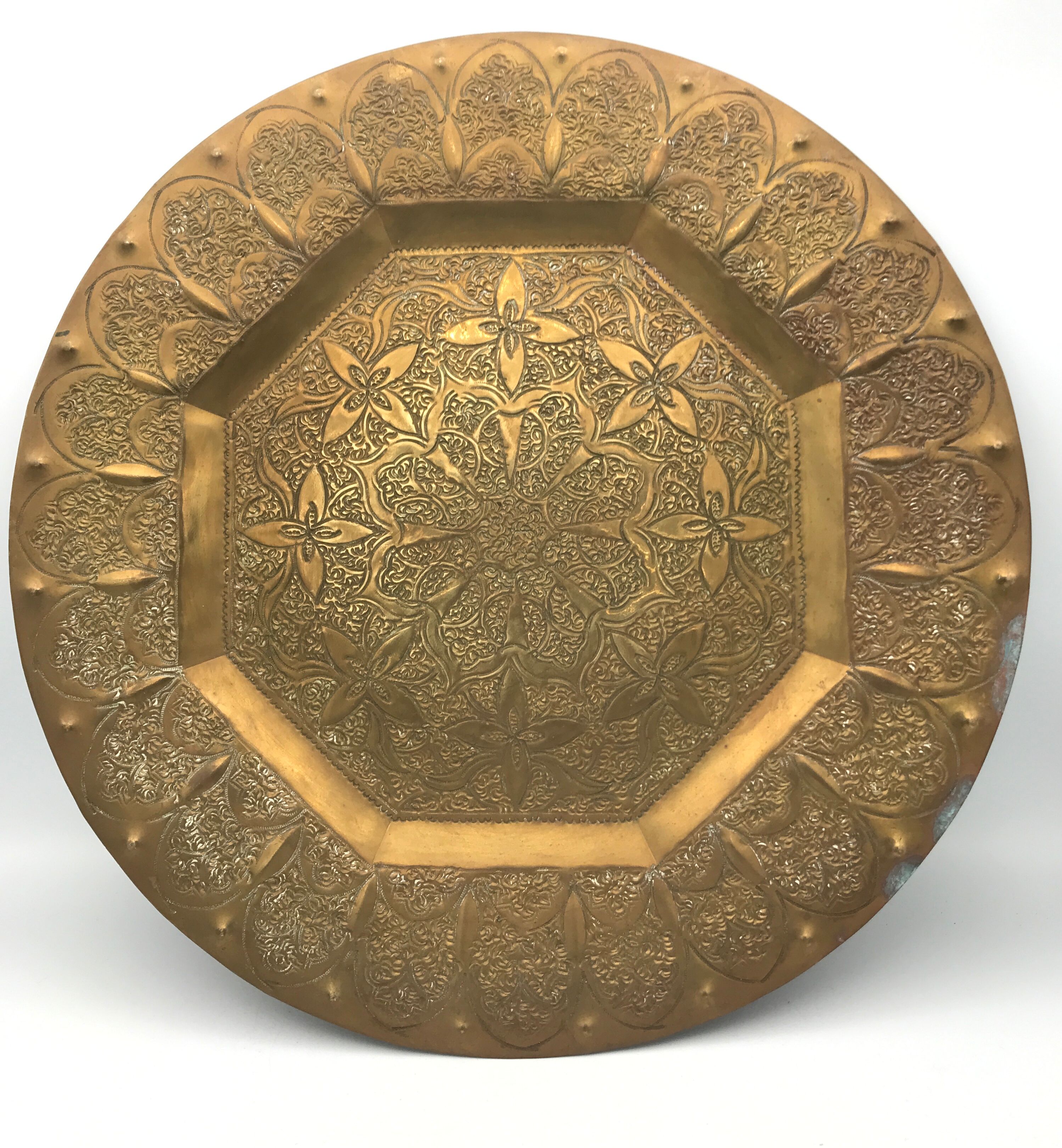 Oriental brass tray with chiseled decoration of arabesques and flowers