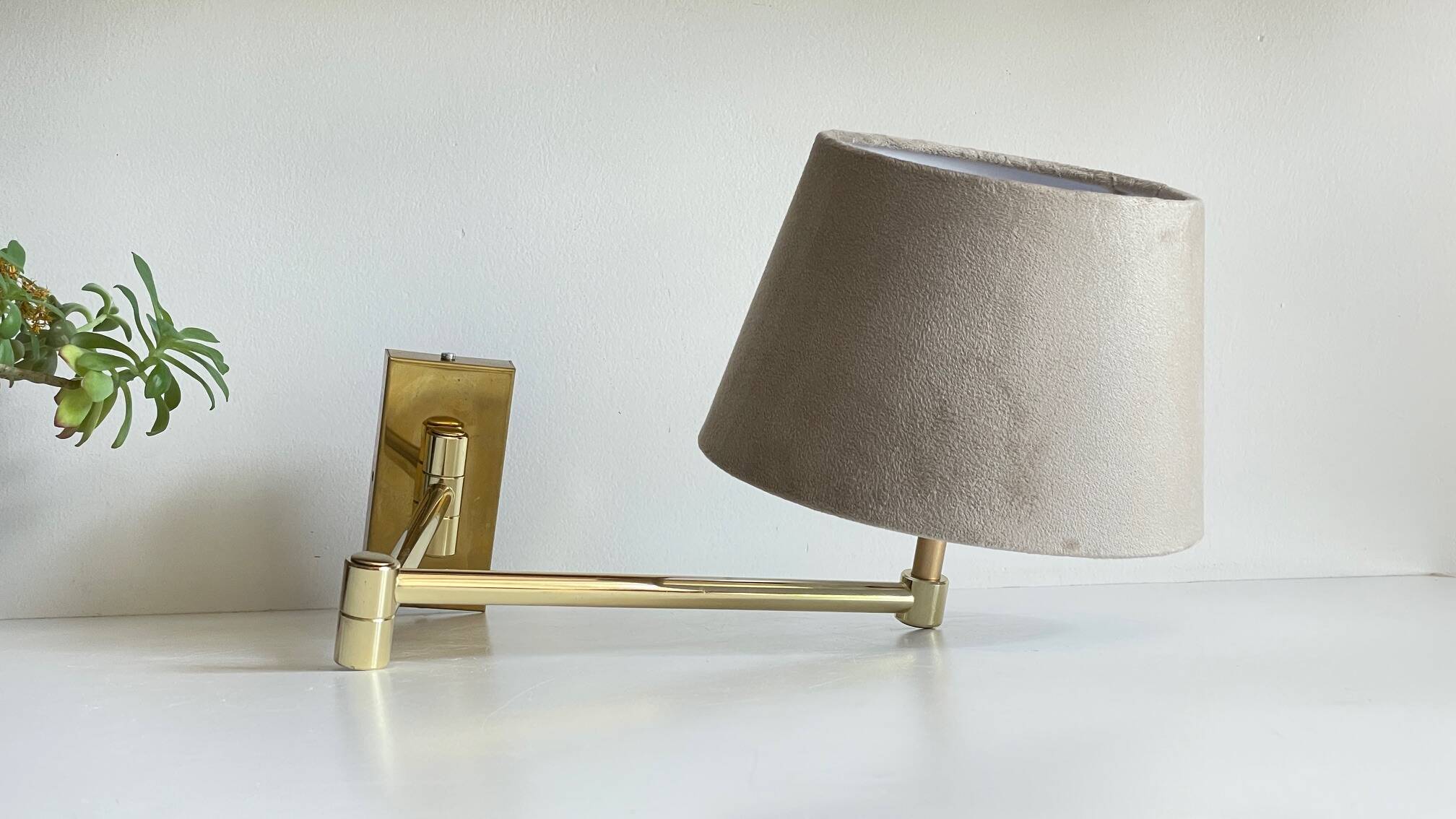 articulated brass and velvet wall light