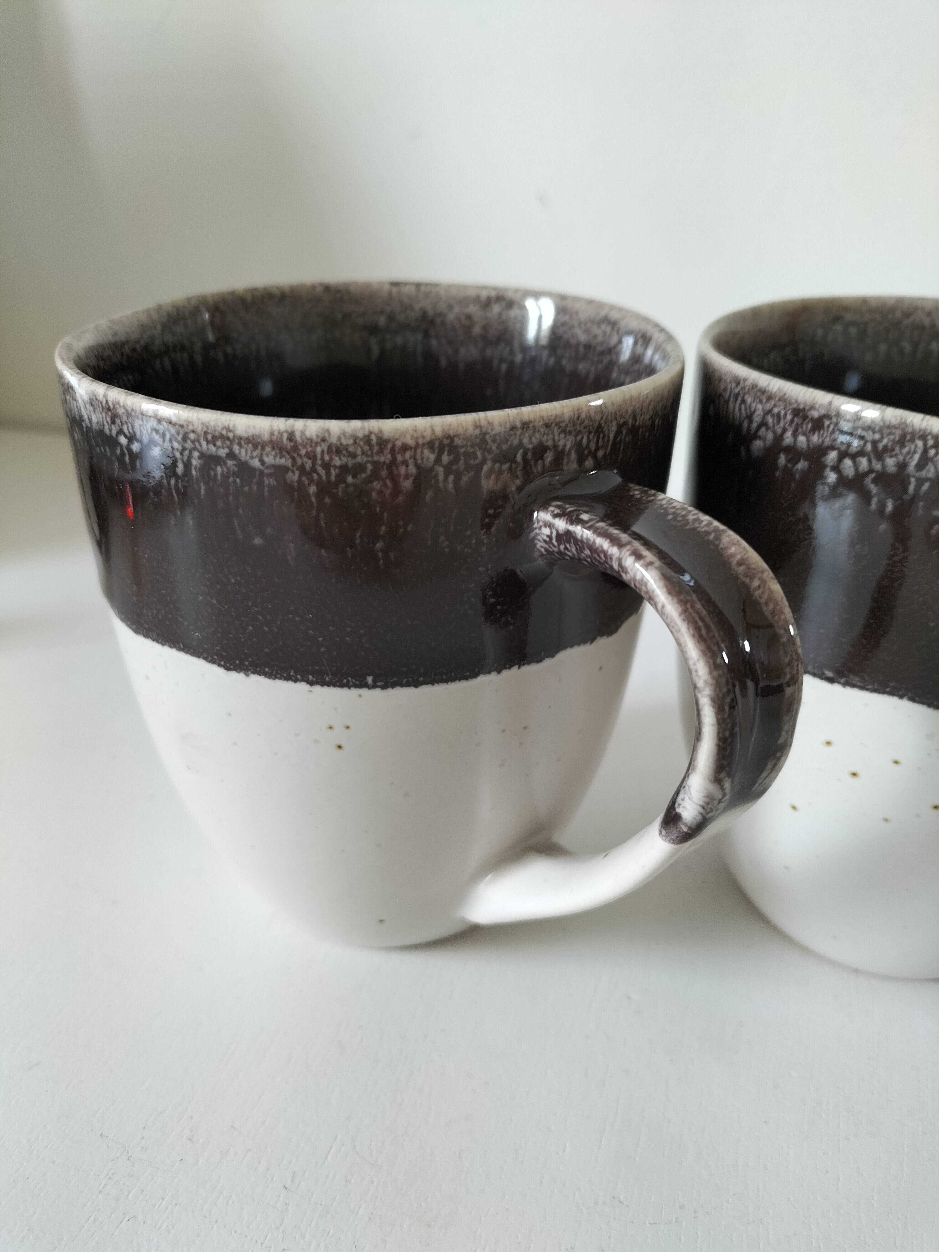 Set of three two-tone mugs, glazed stoneware, café workshop style.