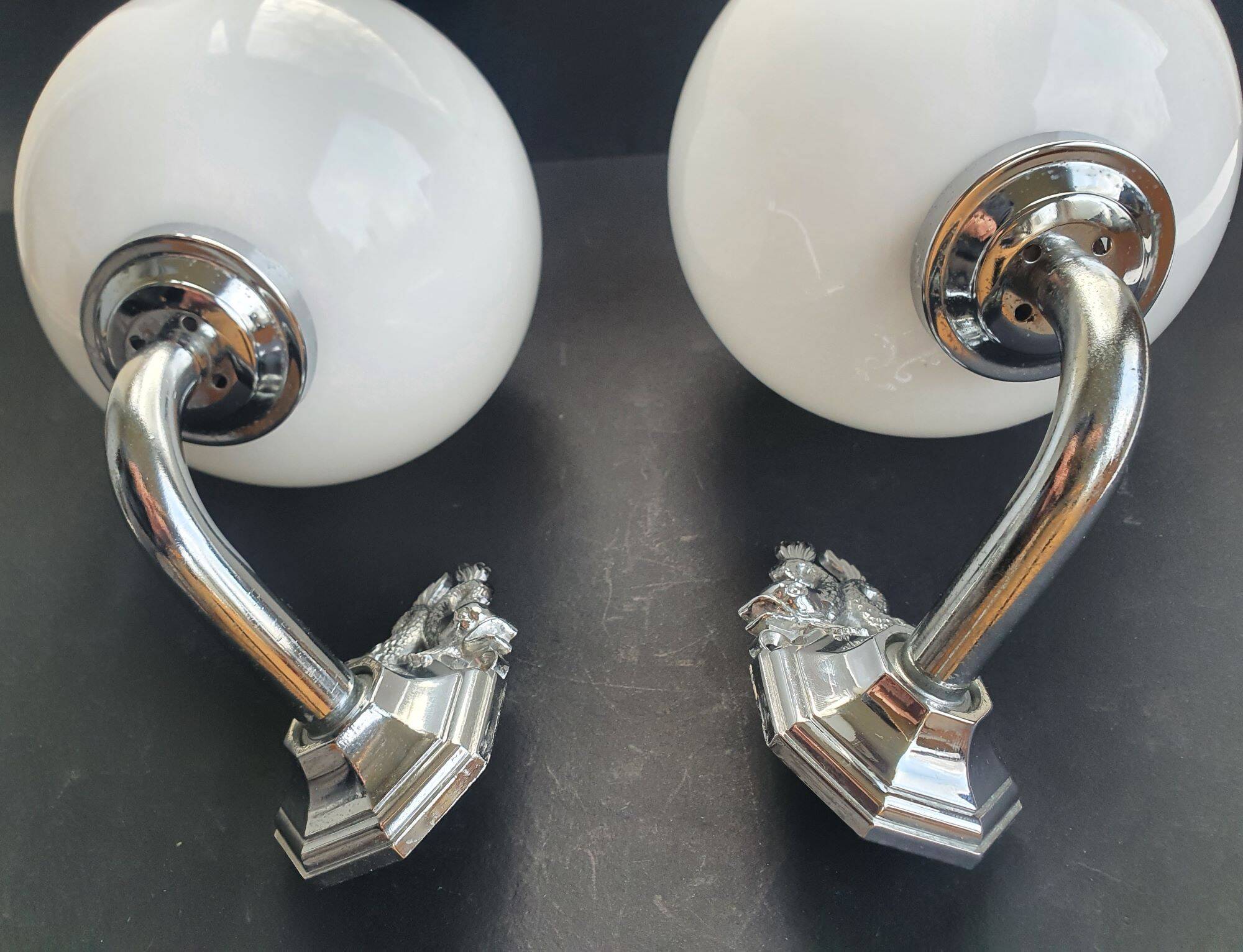 Pair of chrome wall sconces for bathroom with vintage fish pattern.